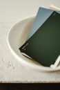 Green Book on White Ceramic Bowl