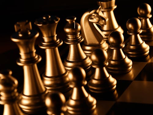 Gold Chess Pieces on Chessboard