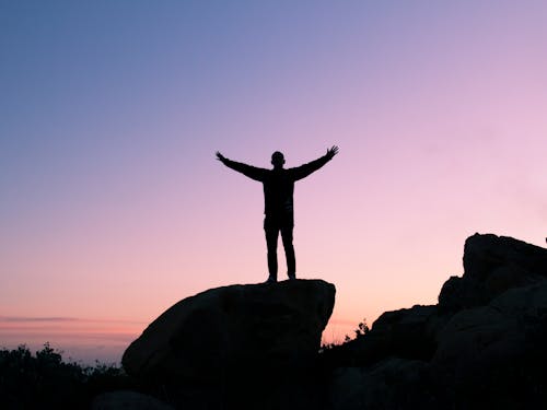 Silhouette of Man Raising His Hands