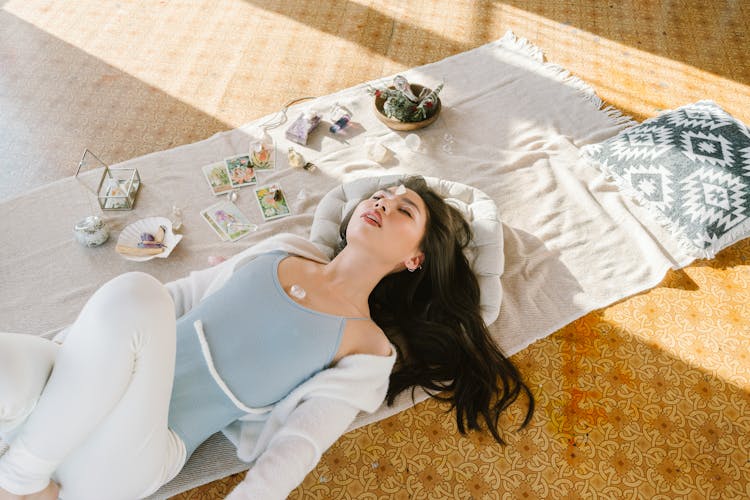 Serene Asian Woman Lying With Chakra Stone On Chest