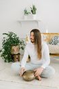 Barefoot male with long hair playing on hapi drum