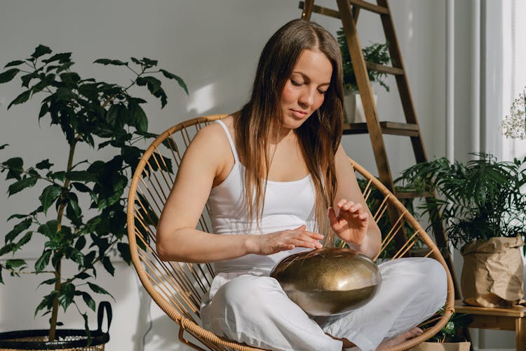 Young Woman Playing On Steel Tongue Drum