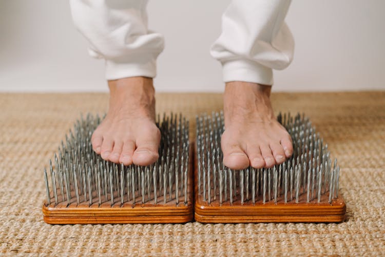 Man Standing On Sharp Nails During Meditation