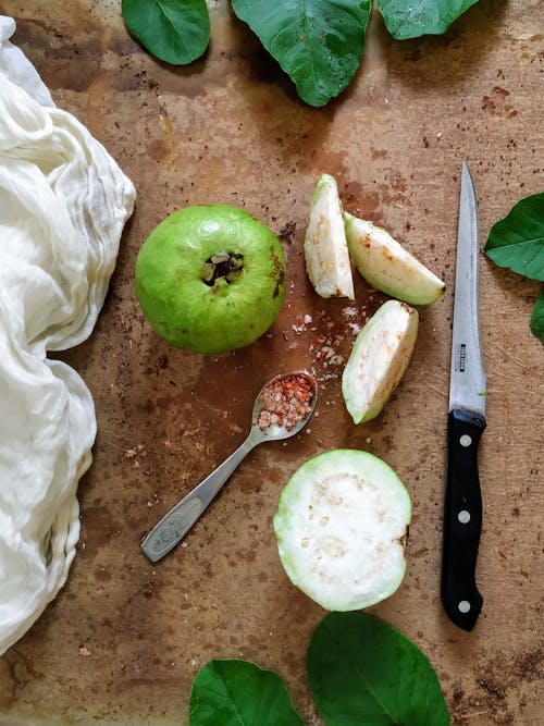 Free Sliced Guava Beside Stainless Steel Spoon Stock Photo