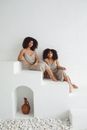 Women Sitting On Stairs Wearing Spaghetti Dress