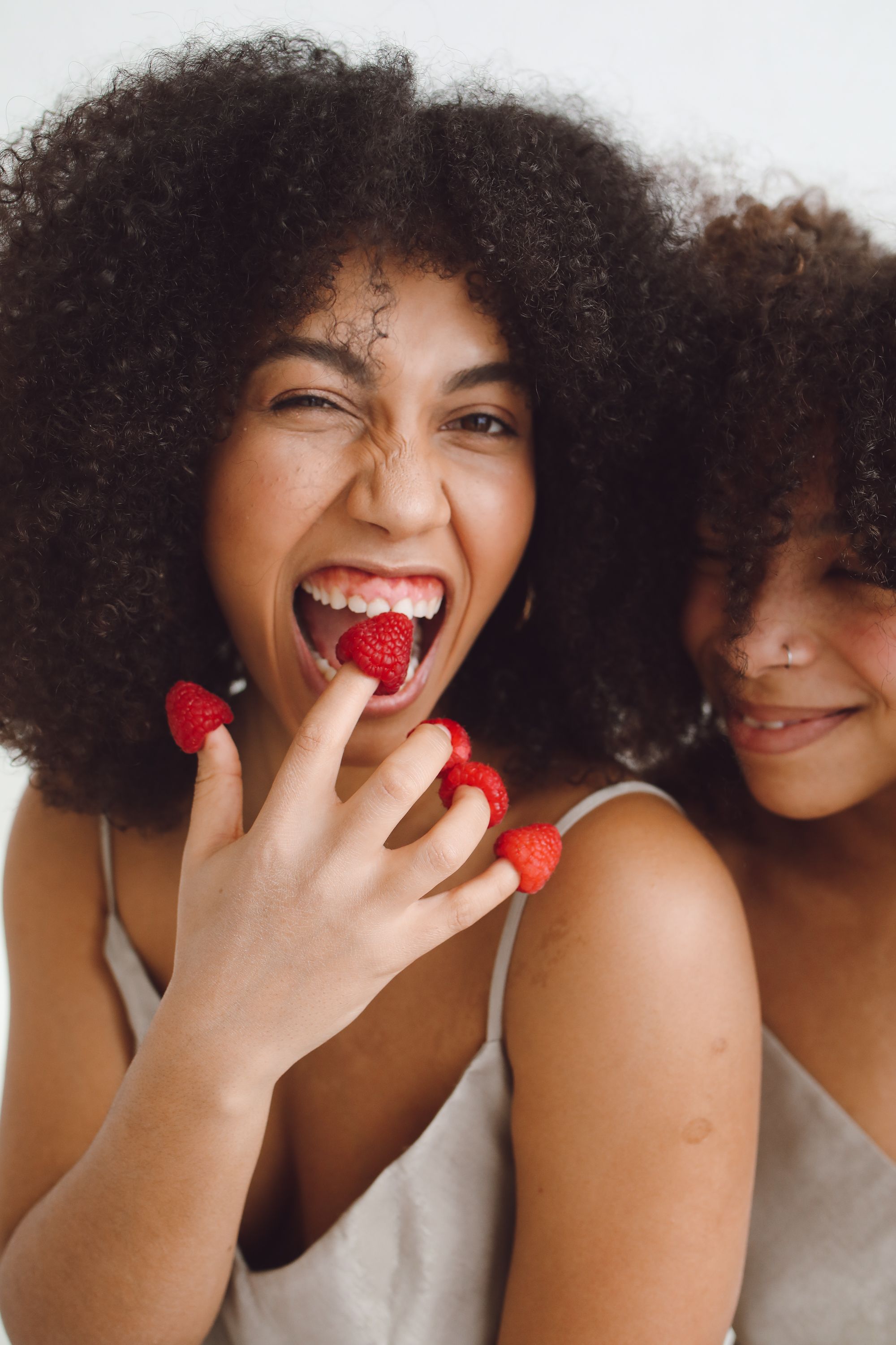 A Smiling Woman with Raspberries on Her Fingers · Free Stock Photo