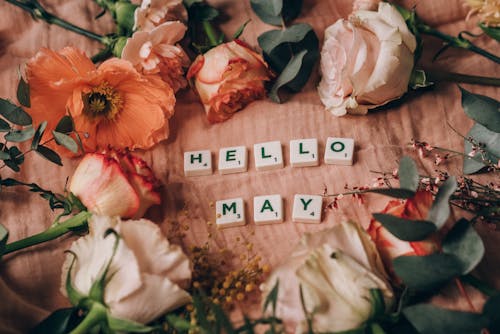 Close-Up Shot of Scrabble Tiles beside Flowers