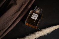 White and Brown Glass Bottle on Black Textile