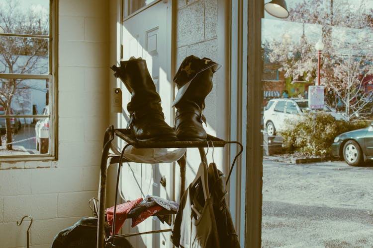 Brown Leather Boots On Rack Near Doorway