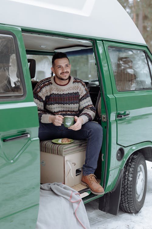 Free Man Having a Coffee Inside a Green Van Stock Photo