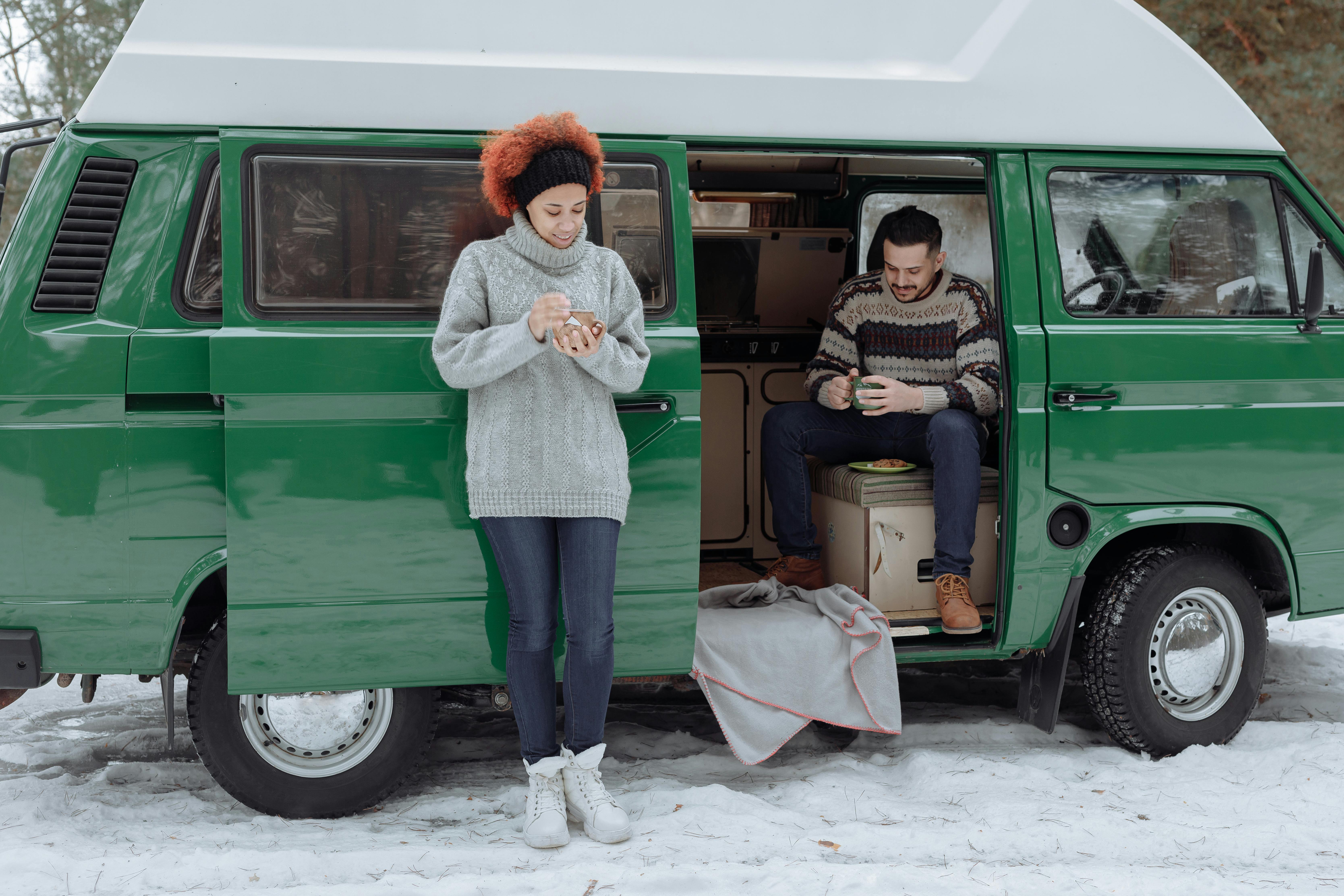 couple living in a green van in the forest