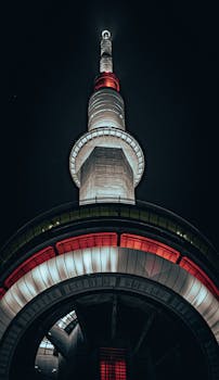 Dramatic low angle shot of the illuminated CN Tower in Toronto at night.