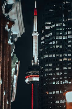 Dramatic night shot of CN Tower and skyscraper, Toronto, Canada.