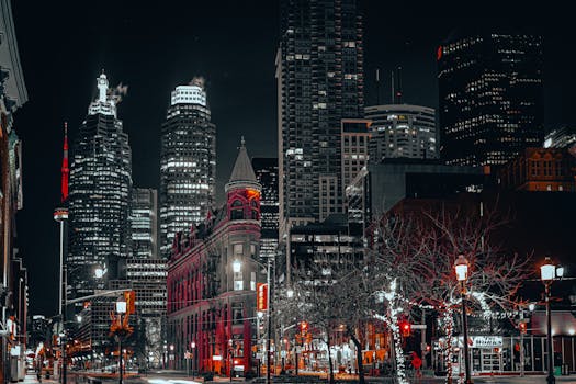 Dramatic Toronto cityscape at night featuring iconic skyscrapers and vibrant lights.