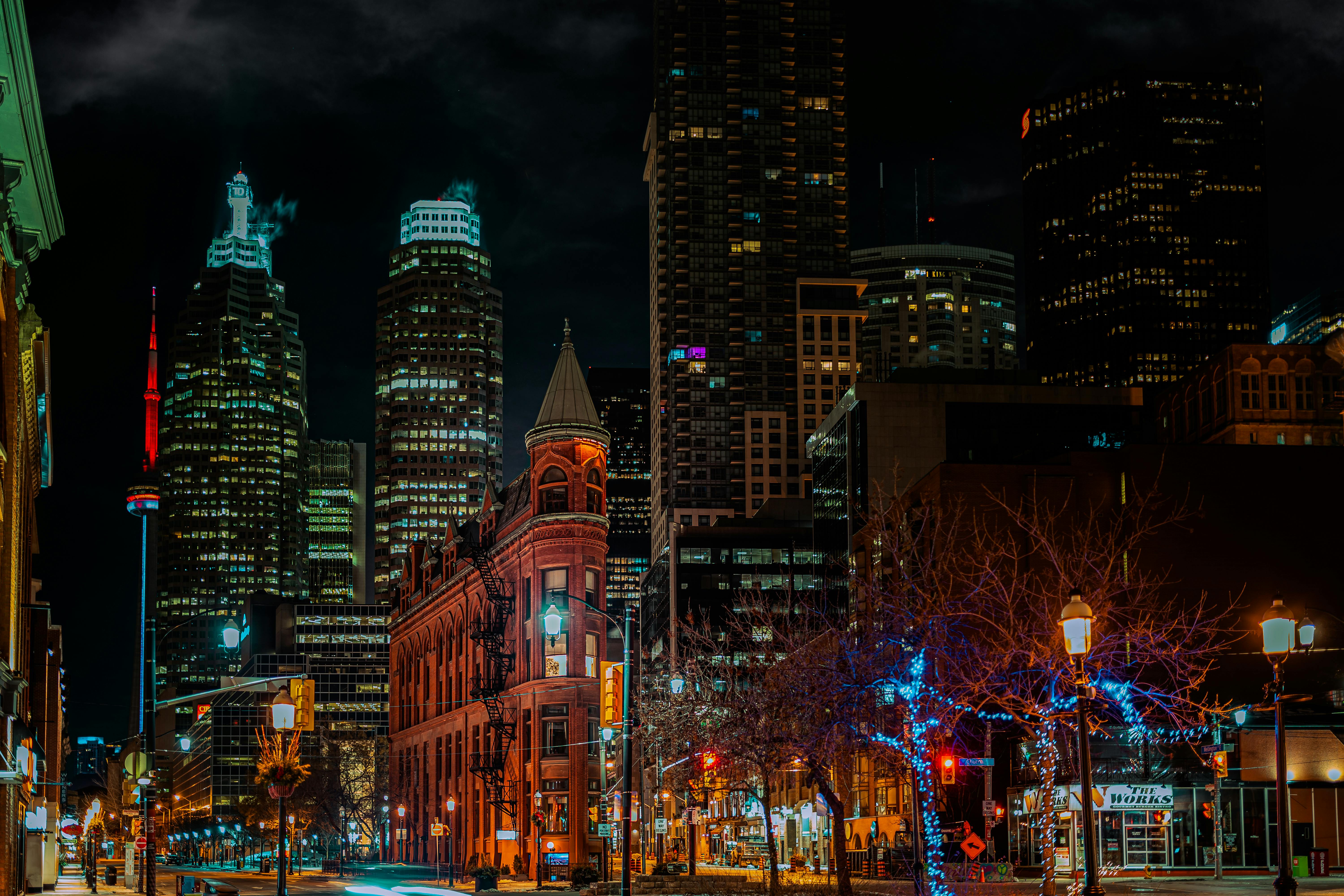 city buildings with lights turned on during night time