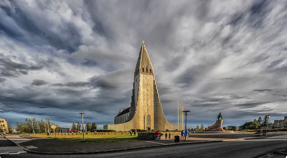 Hallgrímskirkja church towering over Reykjavik with dramatic clouds in the background