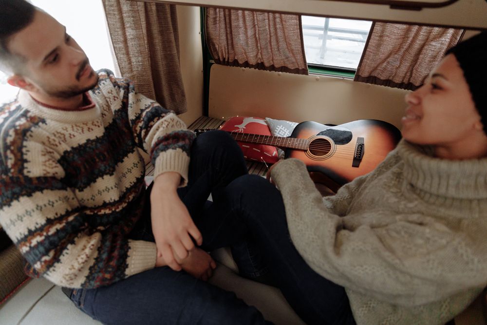 Couple enjoying a cozy moment inside their camper