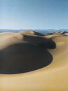 Black and White Hat on Brown Sand