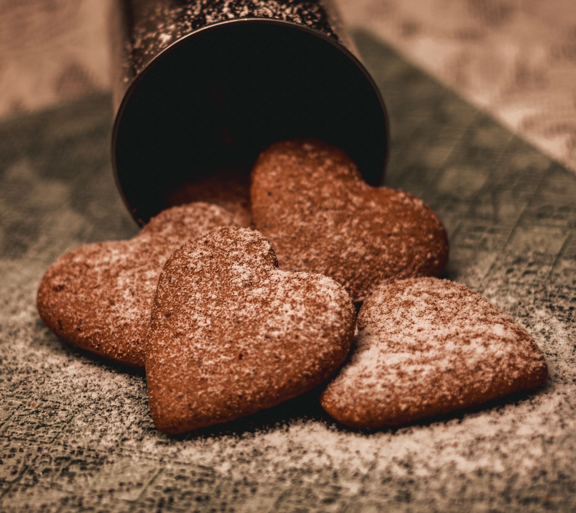 Appetizing heart shaped cookies with sugar powder placed on napkin