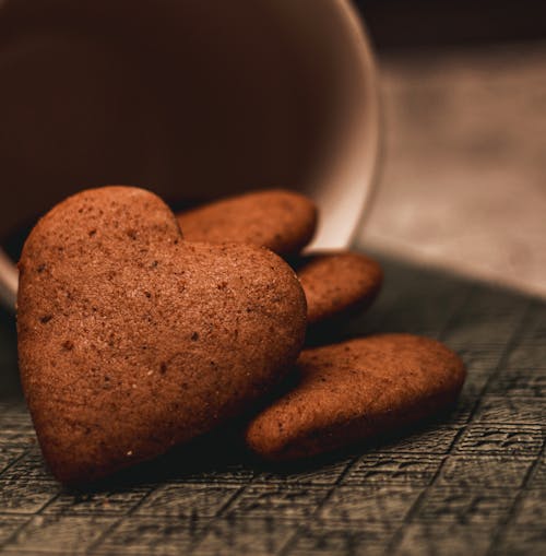 Fresh baked gingerbread heart shaped cookies placed on table