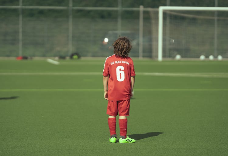 Faceless Teenage Boy Football Player Standing On Field