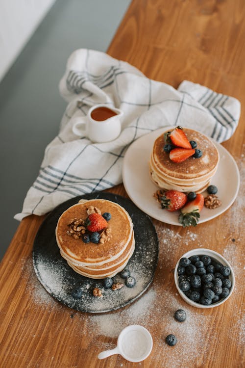 Free Pancakes and Fruits on Plates Stock Photo