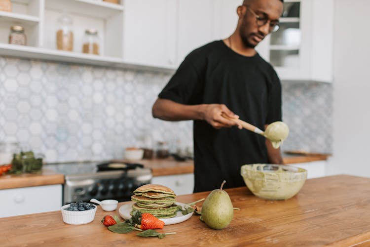 Photo Of A Man Cooking Healthy Pancakes