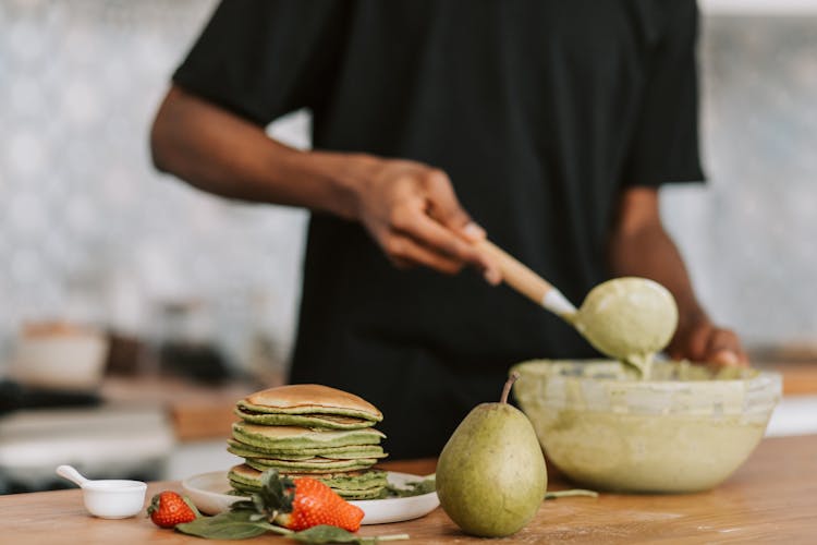 A Person Mixing Batter In A Bowl