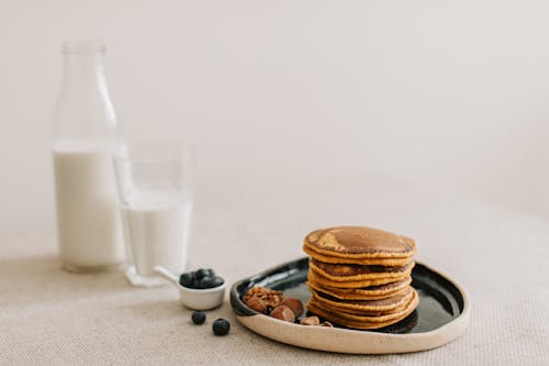 Free Pancakes on a Plate and a Glass of Milk Stock Photo