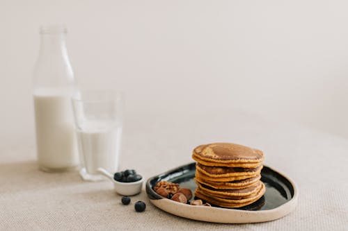 Pancakes on a Plate and a Glass of Milk