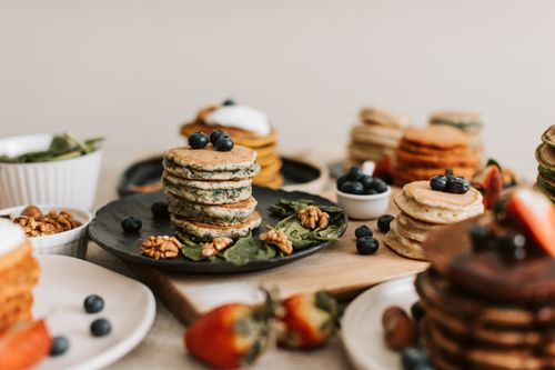 Free A tempting stack of pancakes with blueberries and walnuts, perfect for breakfast. Stock Photo