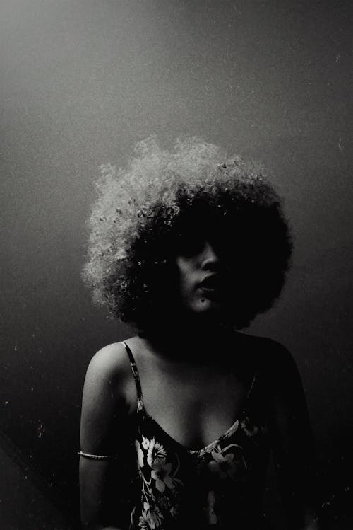 Grayscale Photo of an Afro-Haired Woman 