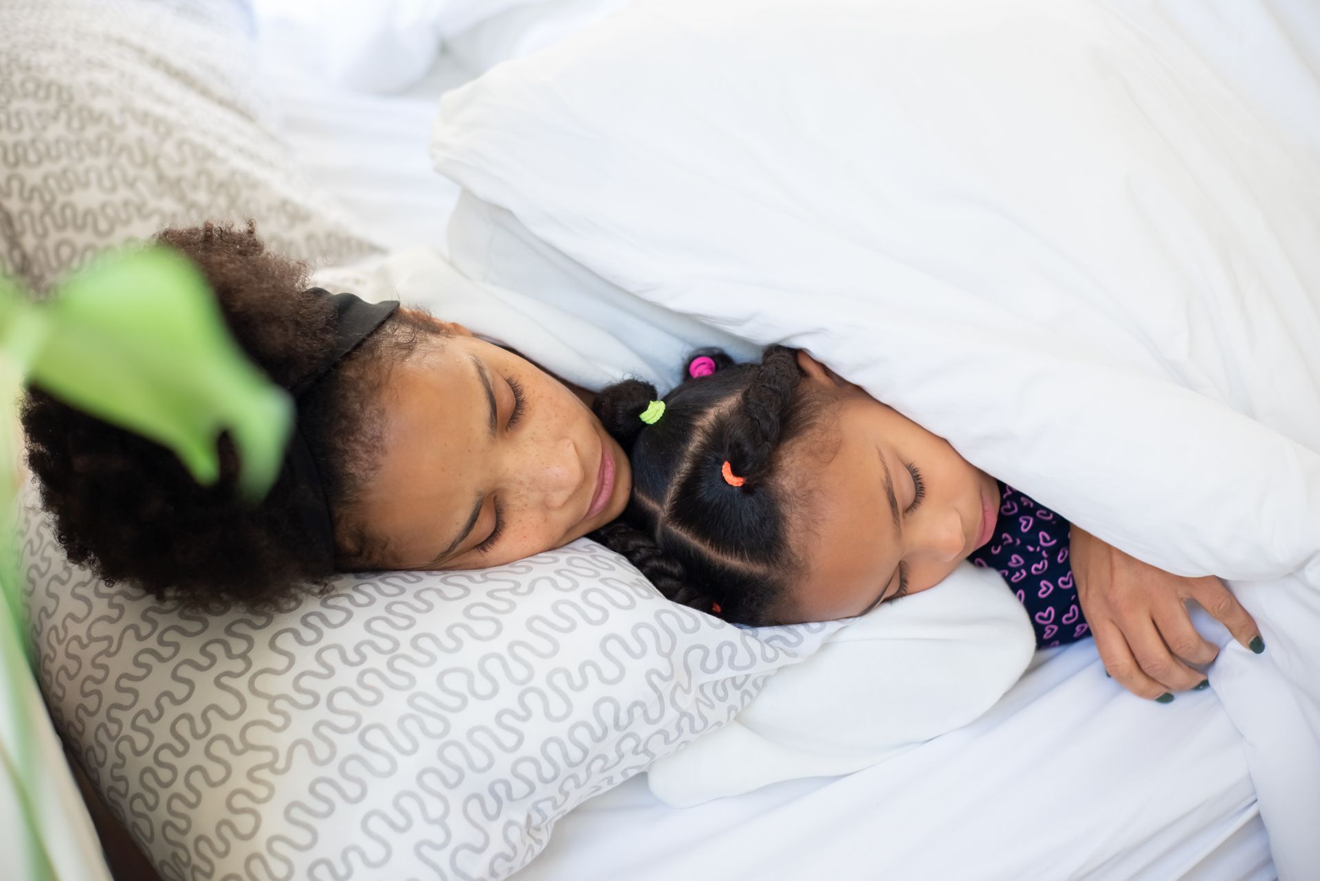 Woman and a Girl Sleeping on Bed
