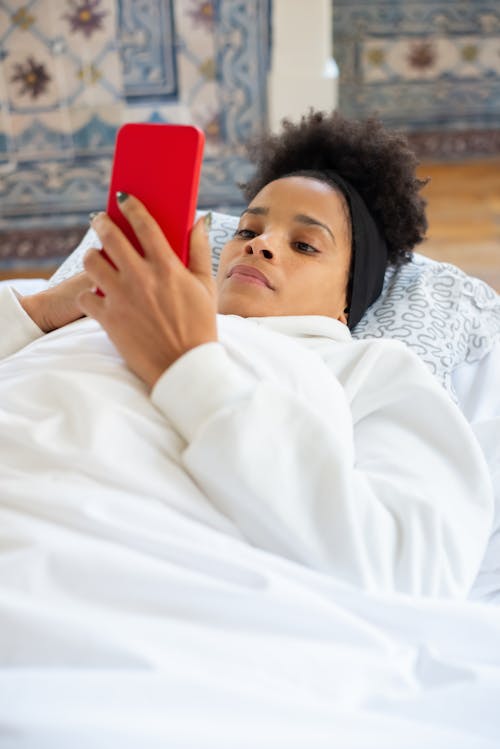 Woman in White Long Sleeve Top Using Cellphone