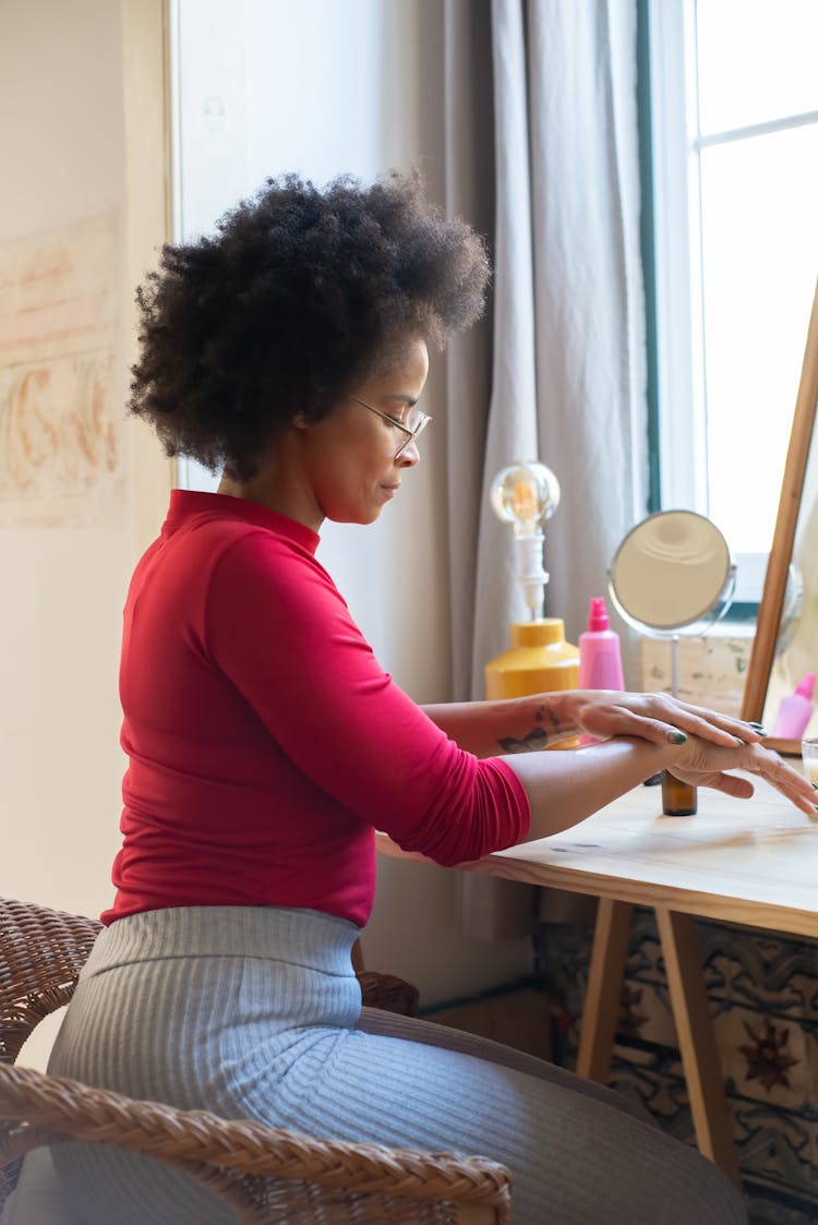 Woman With Afro Hair Moisturizing Her Hands