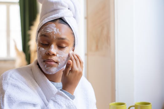 A teenage girl applies facial cream as part of her skincare routine in a cozy indoor setting.