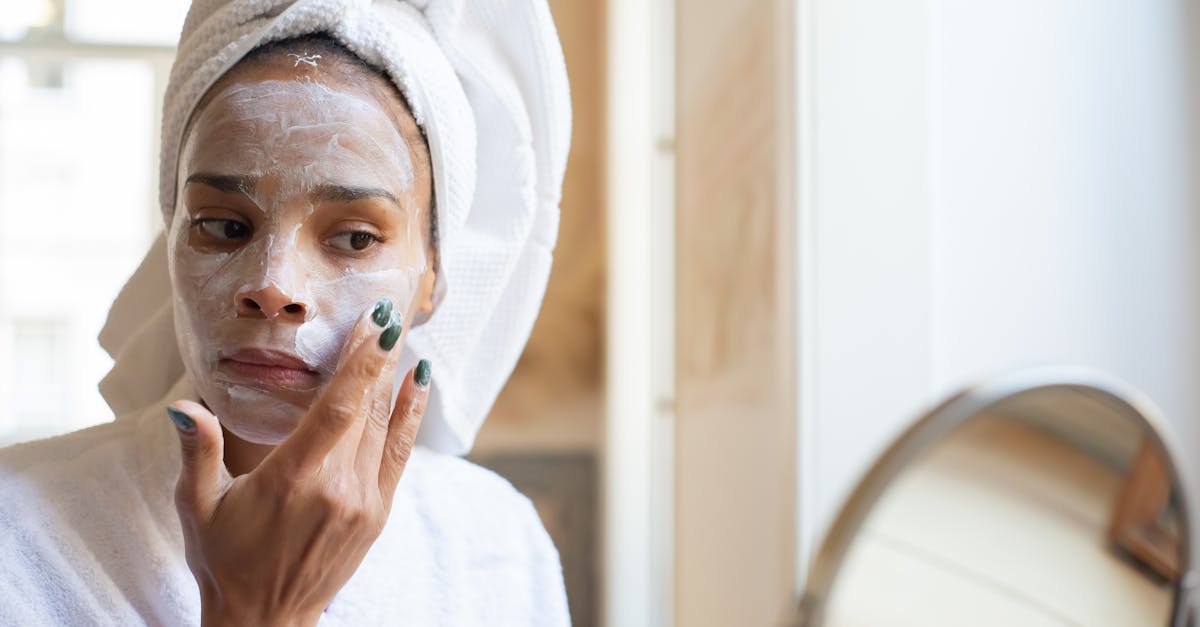 A Woman Applying Moisturizing Cream on her Face