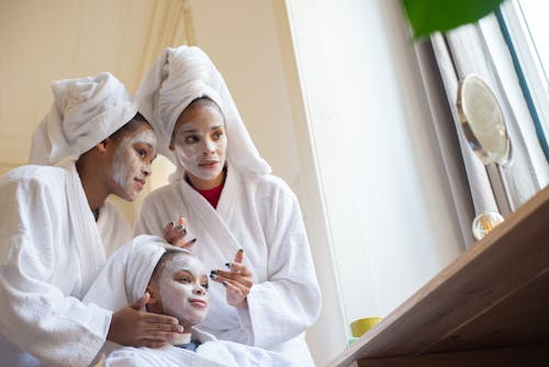 A Mother and Daughters Applying Face Cream