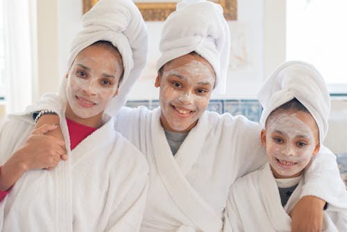 Women and a Young Girl in White Bathrobes