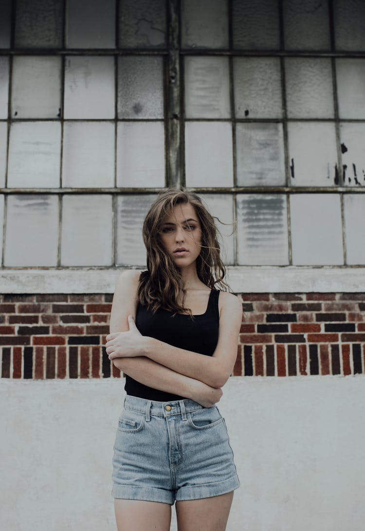 Woman In Black Sleeveless Shirt And Denim Shorts