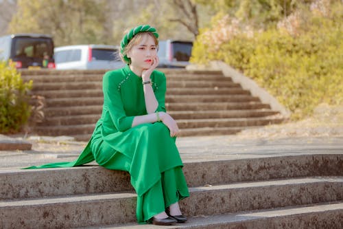 Woman Wearing Green Drees Sitting on Stairs
