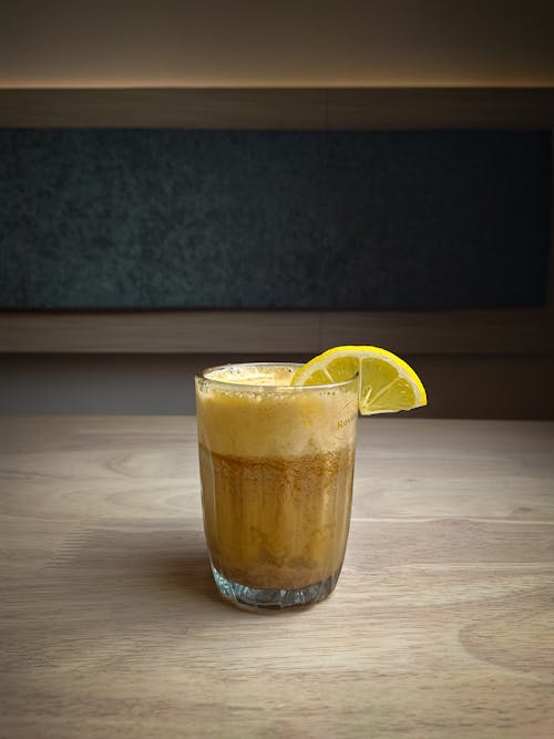 Free Irish Coffee with Slice of Lemon on Wooden Table Stock Photo