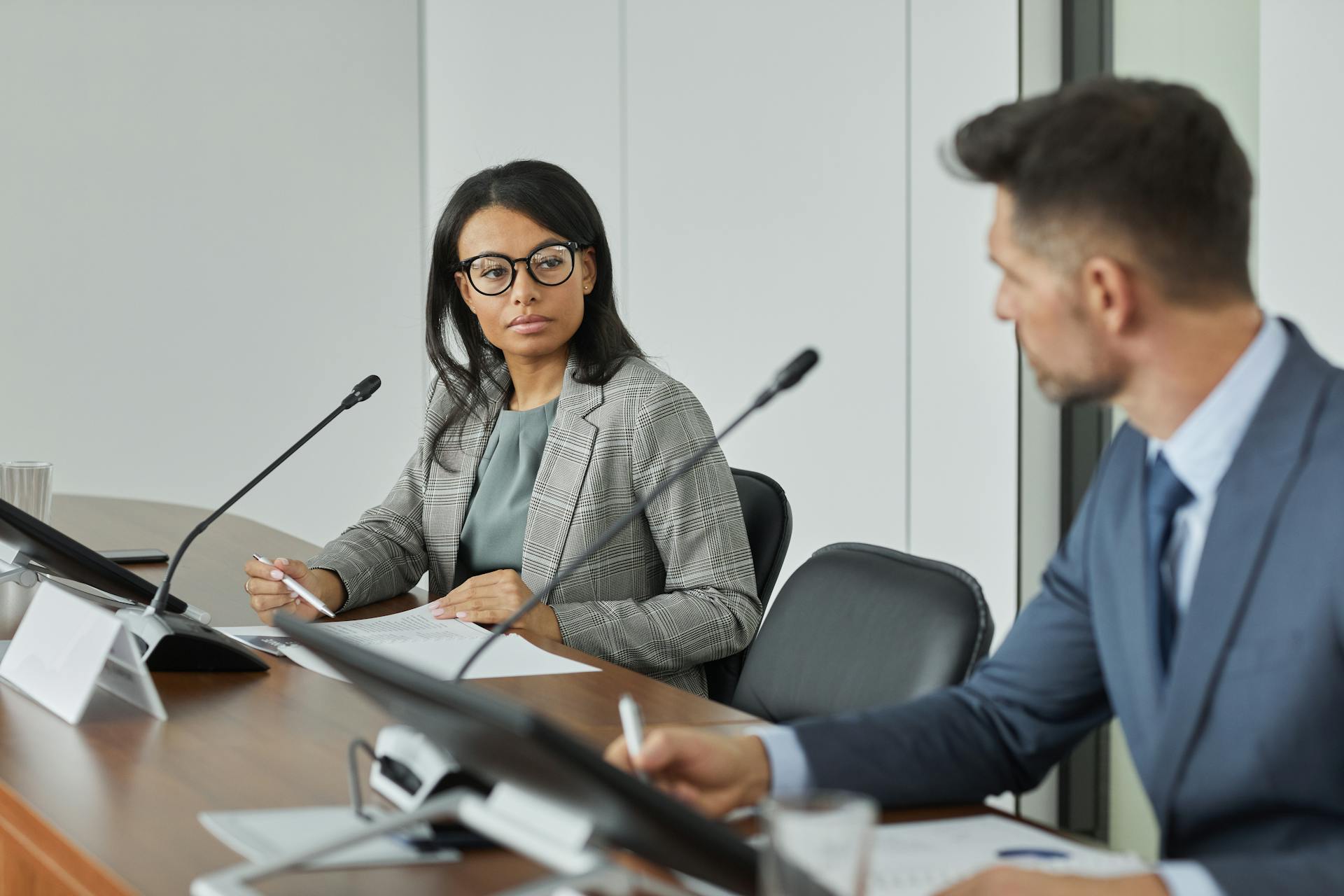 Professional business meeting with diverse leaders in modern conference room setting.