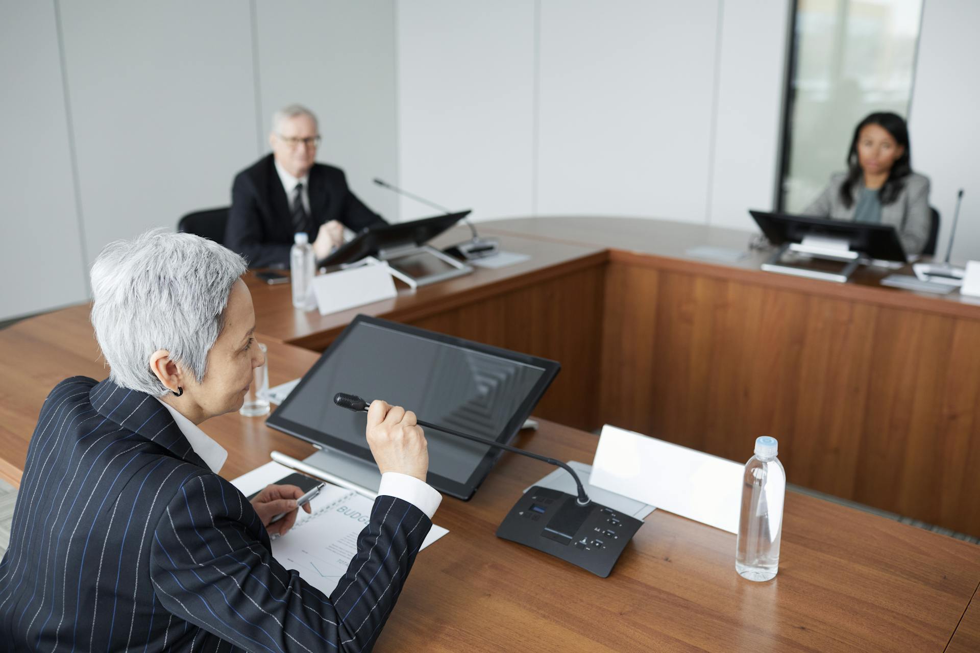 Senior executives discussing strategies in a modern boardroom setting.