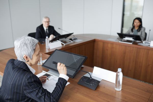 Private equity executives reviewing portfolio performance in a boardroom