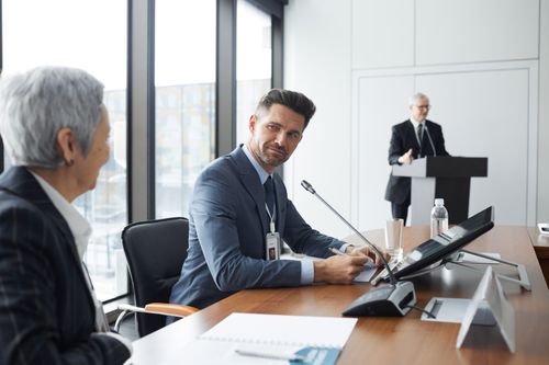 Free Professionals engaging in a business meeting, showcasing a collaborative corporate environment. Stock Photo