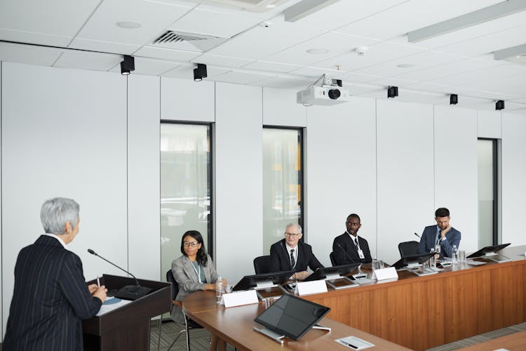 People In A Conference Room Listening To A Speaker