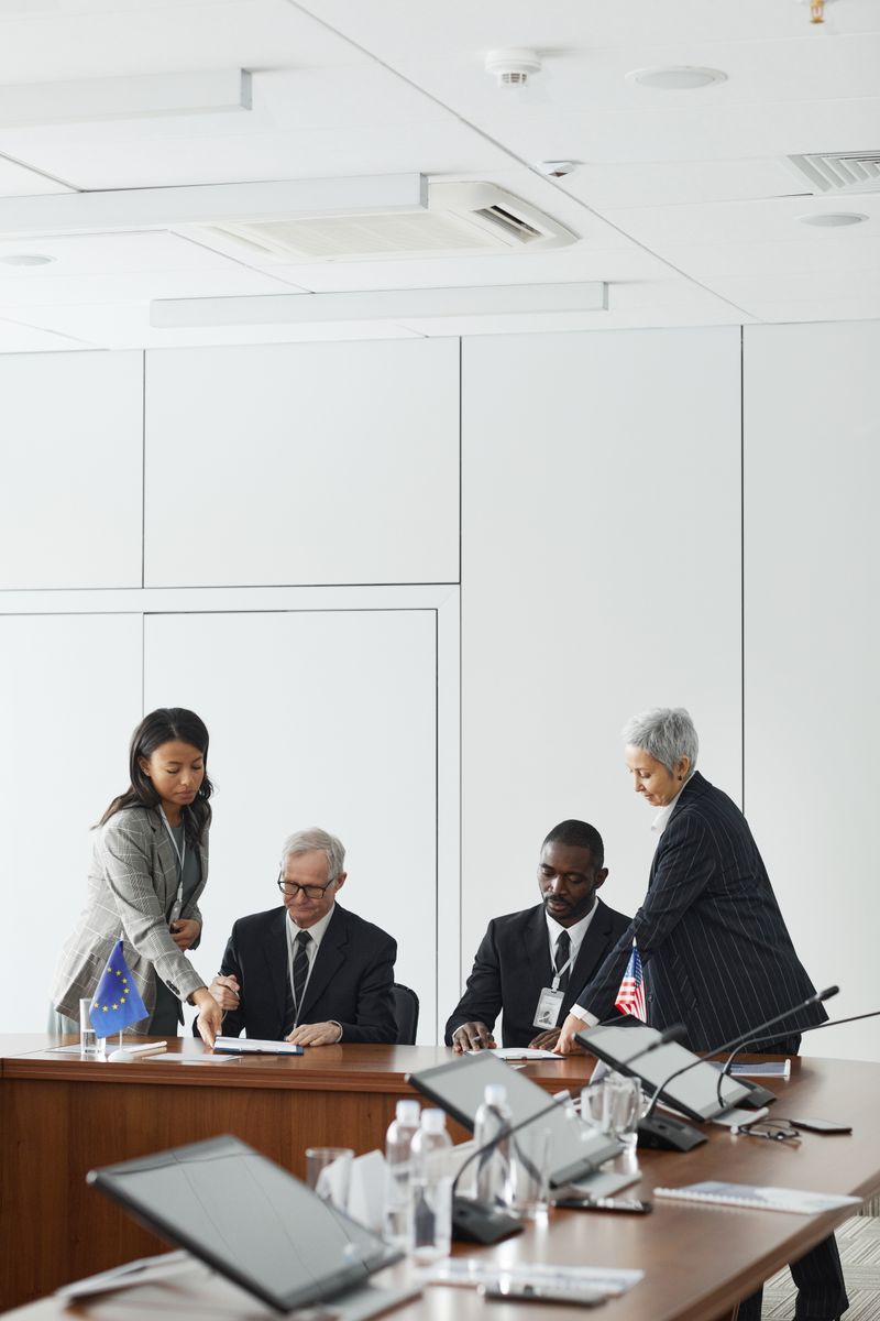 Business professionals engage in a collaborative meeting in a modern office setting.