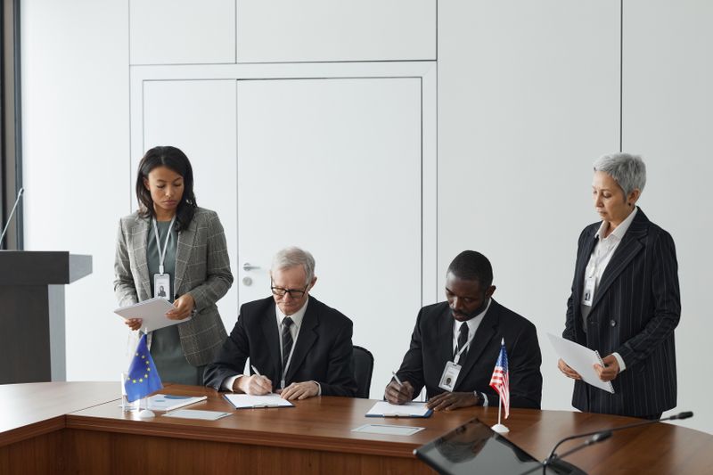 Business leaders signing a significant agreement in a conference room