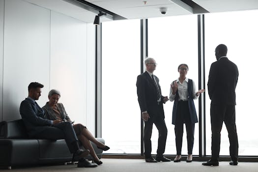 Corporate professionals in discussion during a meeting in a modern office.